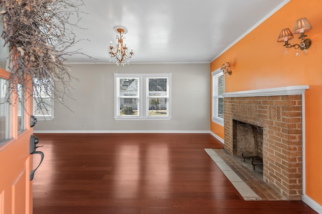 unfurnished living room with dark wood-style floors, a wealth of natural light, and ornamental molding