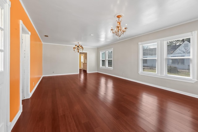 unfurnished living room featuring dark wood-style floors, a notable chandelier, baseboards, and ornamental molding