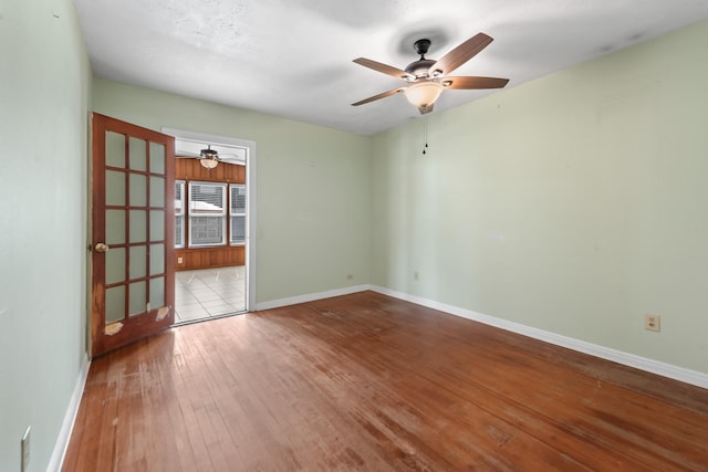 spare room with light wood-style flooring, baseboards, and ceiling fan