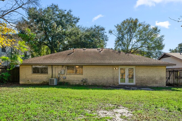 back of house featuring a lawn, fence, french doors, central AC, and brick siding