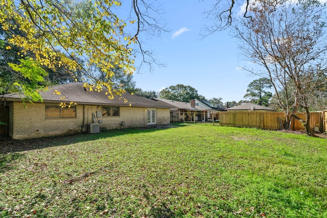 view of yard featuring a fenced backyard and central air condition unit