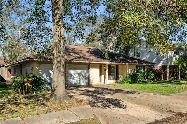 view of front of house featuring concrete driveway, brick siding, an attached garage, and a front yard