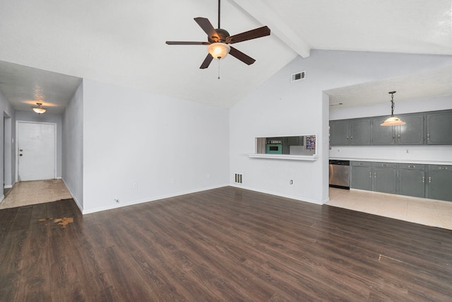 unfurnished living room with dark wood-type flooring, visible vents, vaulted ceiling with beams, and baseboards