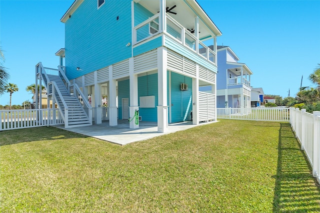 back of house with a patio area, a fenced backyard, stairway, and a lawn