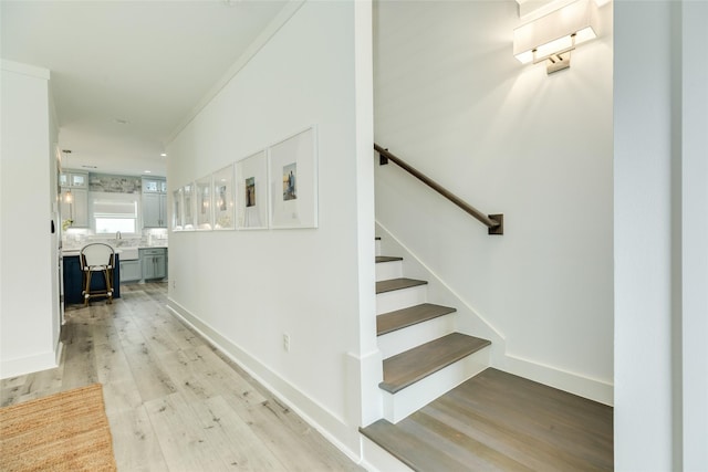 stairs featuring baseboards and wood finished floors