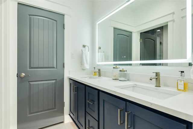 bathroom featuring double vanity and a sink