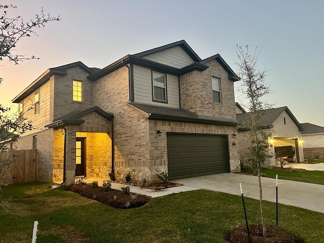 craftsman house featuring a garage, a front lawn, concrete driveway, and brick siding