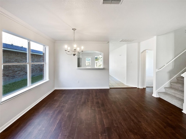 interior space featuring arched walkways, plenty of natural light, and wood finished floors