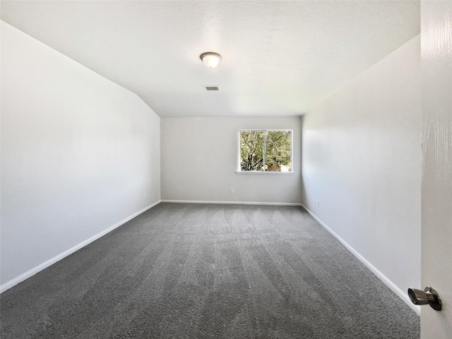 empty room with carpet flooring, visible vents, and baseboards