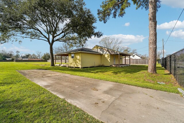 view of home's exterior with fence and a lawn