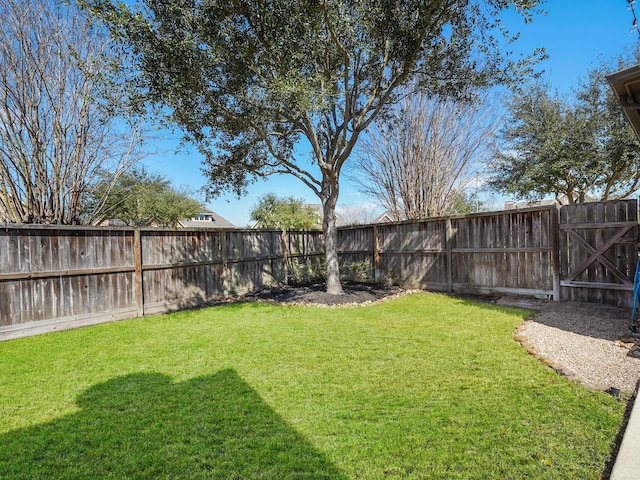 view of yard with a fenced backyard