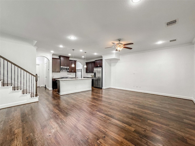 717 Via Lago, Webster, TX 77598 - unfurnished living room featuring arched walkways, a ceiling fan, crown molding, dark wood-style floors, and baseboards