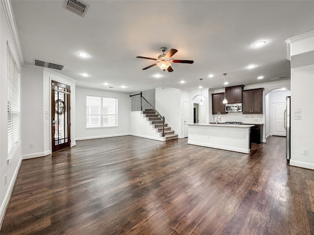717 Via Lago, Webster, TX 77598 - unfurnished living room with a ceiling fan, arched walkways, recessed lighting, baseboards, and ornamental molding