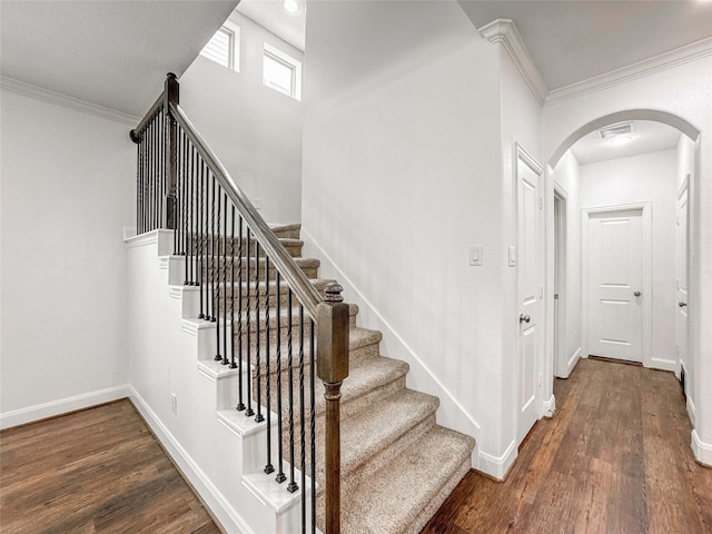 717 Via Lago, Webster, TX 77598 - stairs featuring arched walkways, ornamental molding, wood finished floors, and baseboards