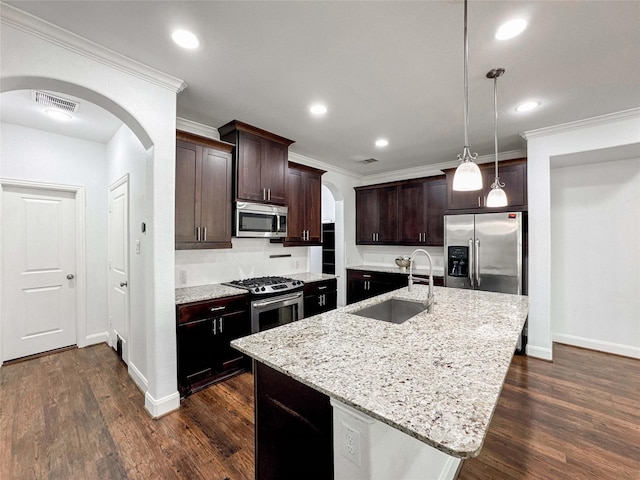 717 Via Lago, Webster, TX 77598 - kitchen featuring arched walkways, appliances with stainless steel finishes, a sink, baseboards, and ornamental molding