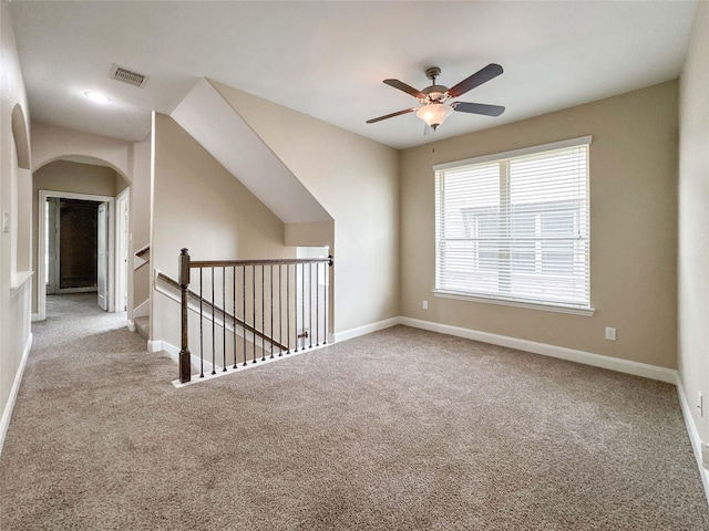 717 Via Lago, Webster, TX 77598 - empty room featuring arched walkways, carpet floors, a ceiling fan, and baseboards