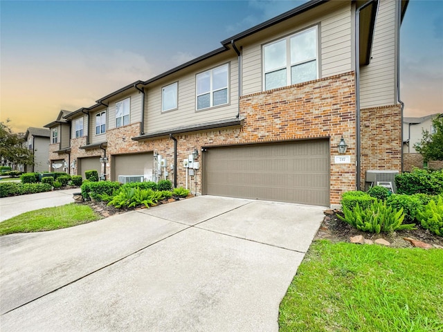 717 Via Lago, Webster, TX 77598 - multi unit property featuring brick siding, an attached garage, concrete driveway, and central AC