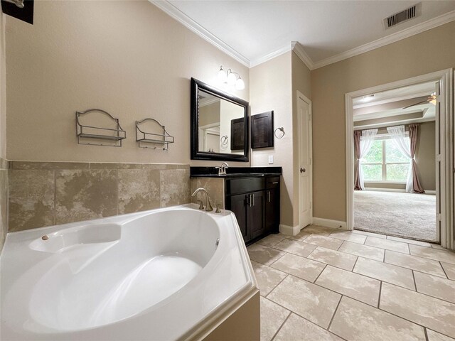 717 Via Lago, Webster, TX 77598 - full bathroom featuring vanity, a garden tub, ornamental molding, and baseboards