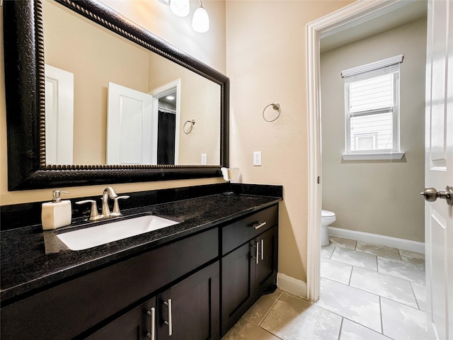 717 Via Lago, Webster, TX 77598 - full bathroom featuring vanity, toilet, and baseboards