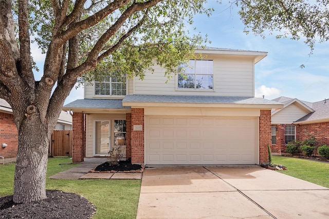 traditional home featuring an attached garage, fence, concrete driveway, and brick siding