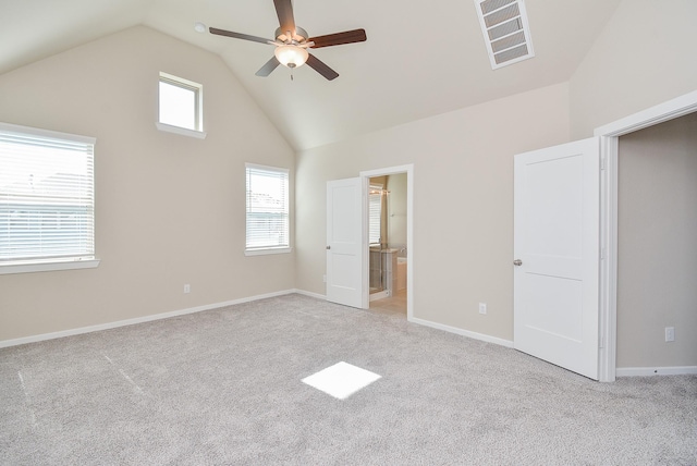 unfurnished bedroom with high vaulted ceiling, visible vents, light carpet, and baseboards