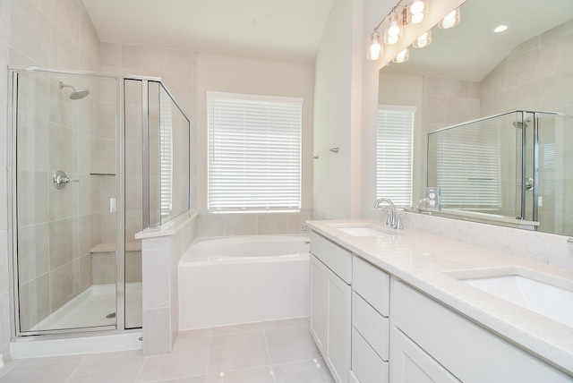 full bath with a stall shower, a garden tub, a sink, and tile patterned floors