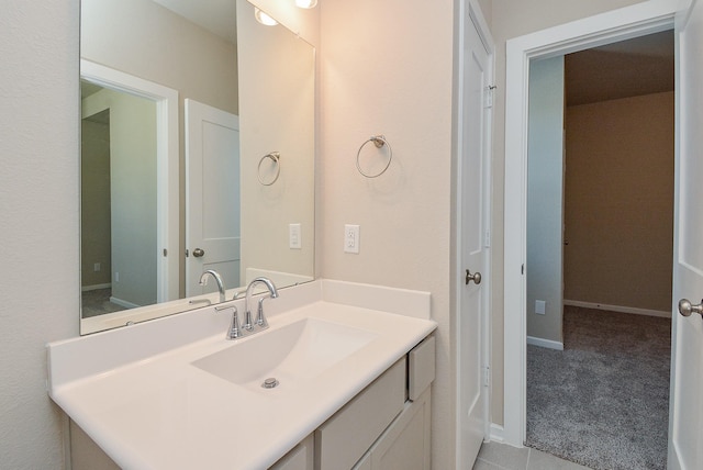 bathroom with vanity and baseboards