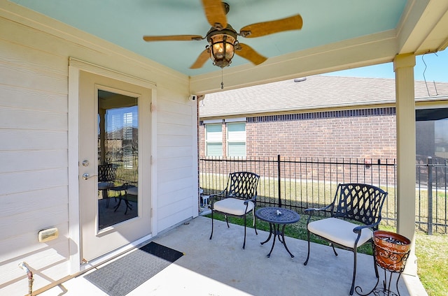 view of patio with ceiling fan and fence