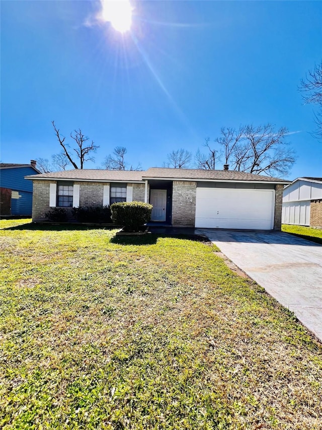 ranch-style home featuring a garage, concrete driveway, brick siding, and a front yard