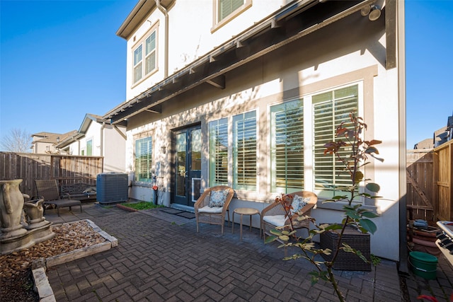 view of patio / terrace with fence and central AC unit