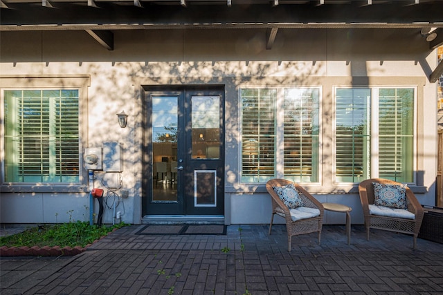 view of exterior entry with a patio