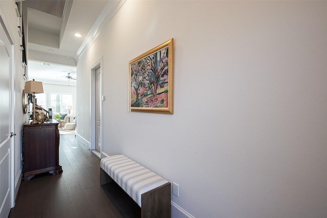 hallway with ornamental molding, recessed lighting, dark wood finished floors, and baseboards