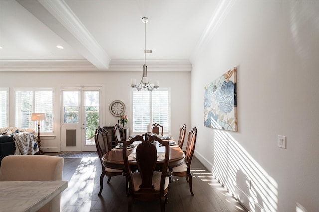 dining space featuring dark wood-style floors, crown molding, visible vents, an inviting chandelier, and baseboards