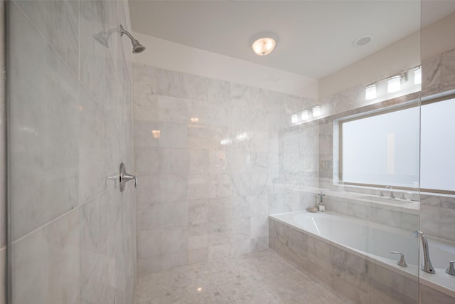 bathroom featuring a garden tub and tiled shower