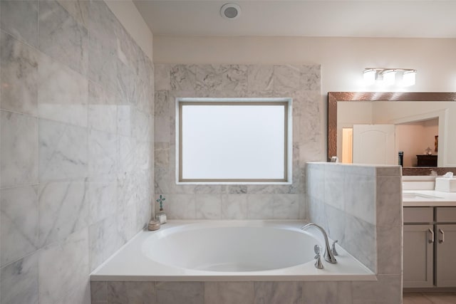 bathroom with a bath and vanity