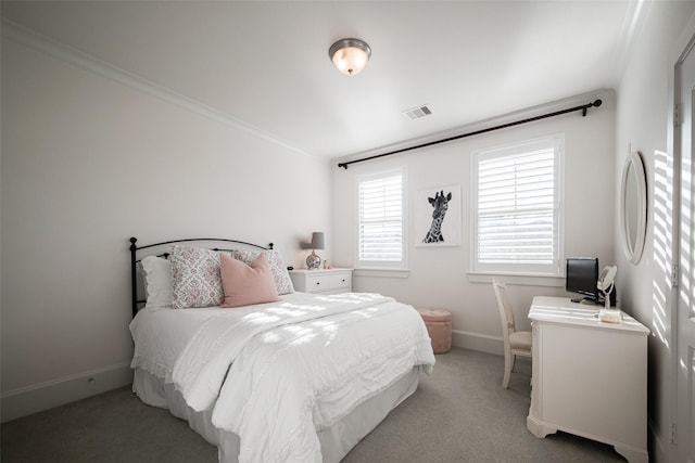 bedroom featuring baseboards, ornamental molding, visible vents, and light colored carpet