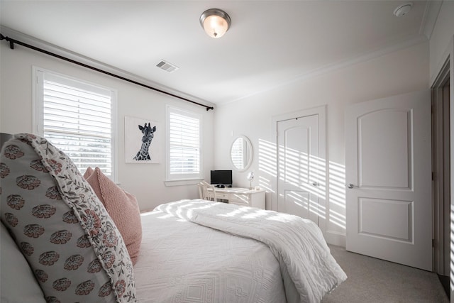 bedroom featuring visible vents and light carpet