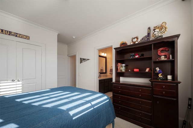 bedroom with ensuite bath, a closet, and crown molding