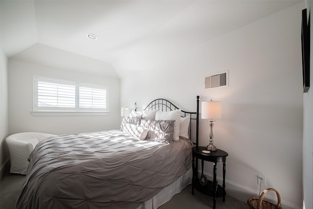 bedroom with vaulted ceiling, visible vents, and baseboards