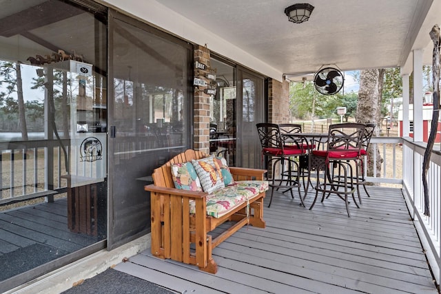 wooden terrace with outdoor dining space