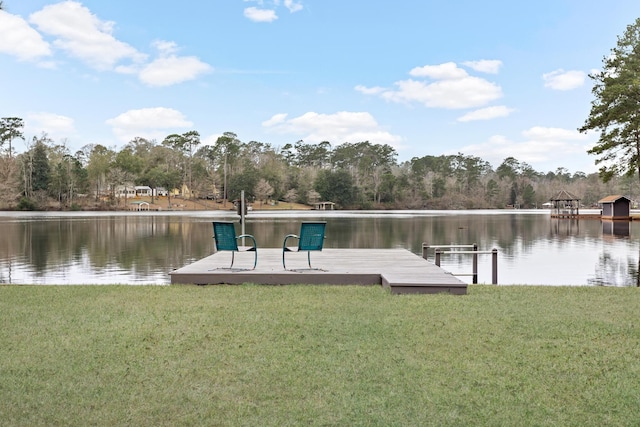 view of dock with a yard and a water view