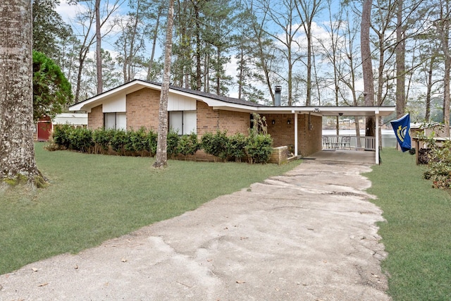 view of front facade featuring concrete driveway, brick siding, and a front lawn