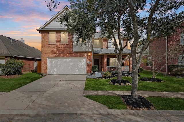 view of front of property featuring brick siding, a yard, a porch, an attached garage, and driveway