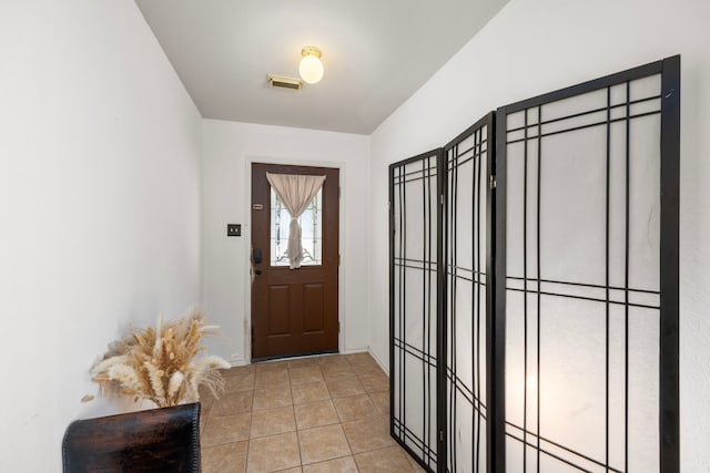 doorway featuring tile patterned flooring and visible vents