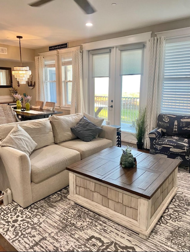 living room with recessed lighting, visible vents, and a chandelier