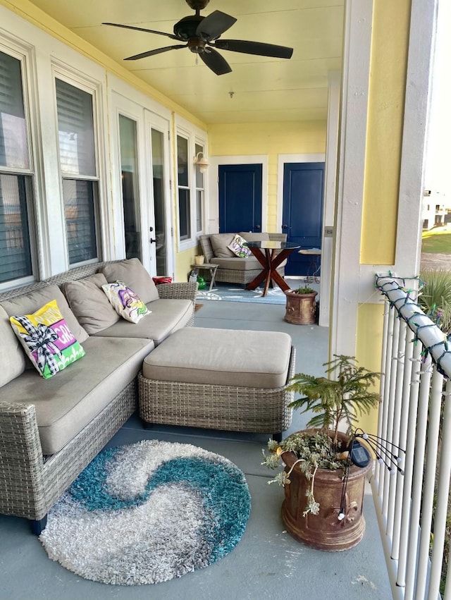 balcony with an outdoor living space, french doors, and ceiling fan