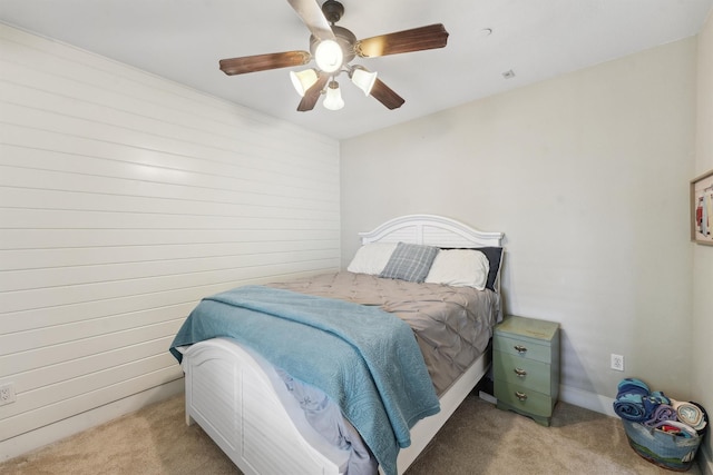 bedroom with a ceiling fan and light colored carpet