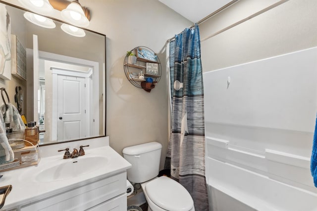 bathroom featuring vanity, toilet, and shower / tub combo with curtain