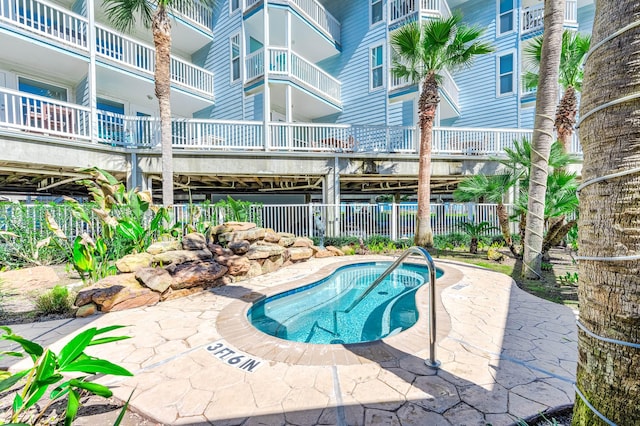 view of pool featuring fence