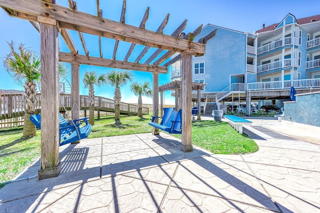 view of patio featuring fence and a pergola